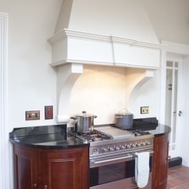 Curved solid wood cabinets  ( hand painted chinmey detail with extractor fan )